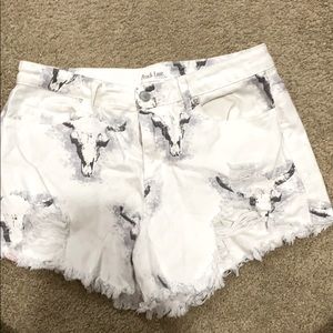 Peach love distressed cow skull denim shorts